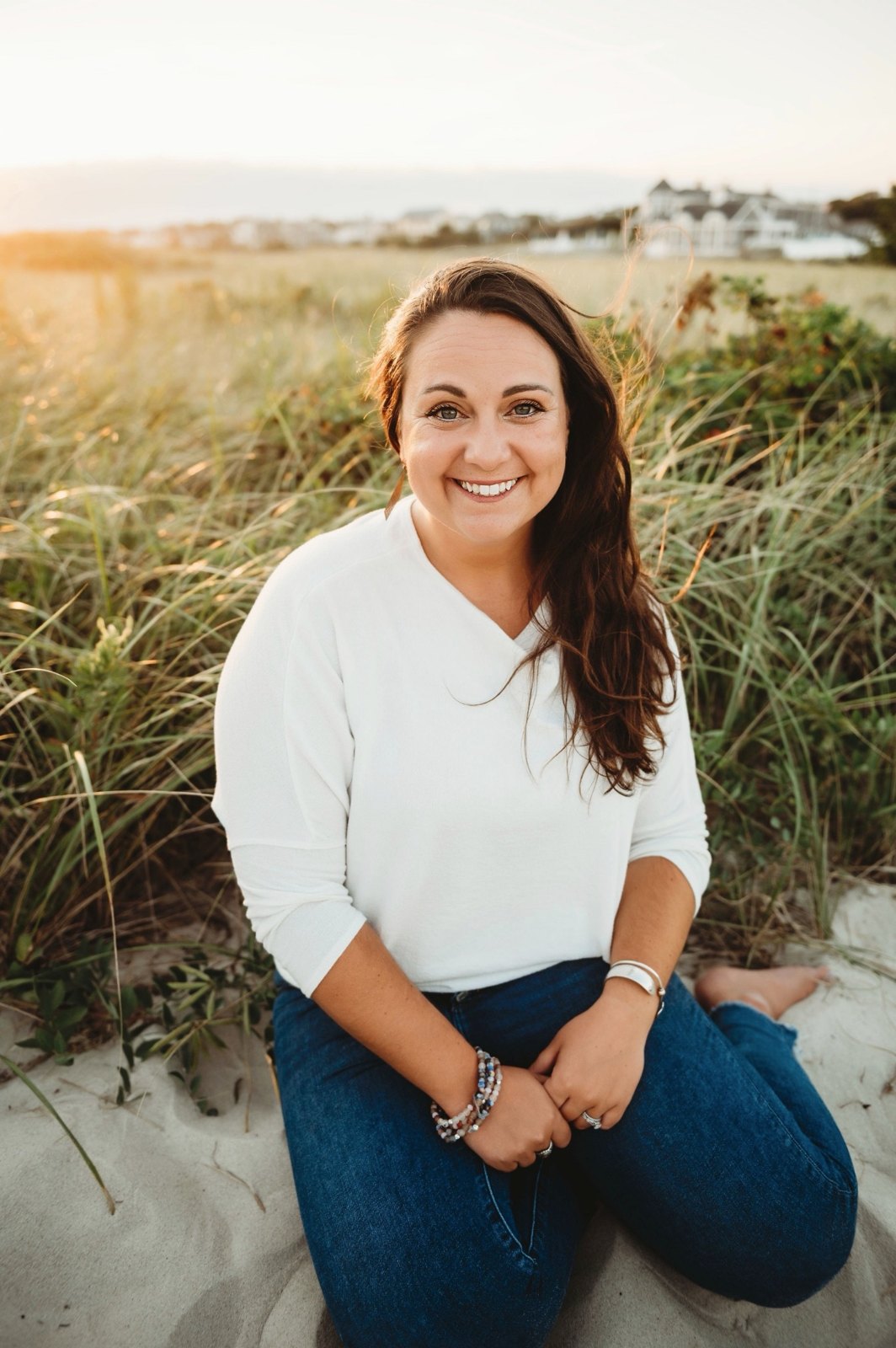 Allie Agro seated in the Cape Cod dunes at sunset
